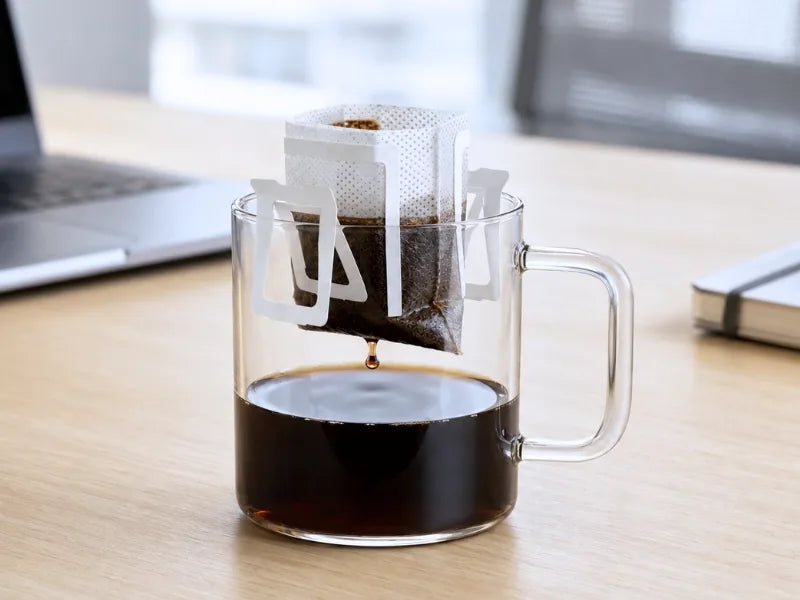 A cold cup of KNDZ coffee brewed from a single-serve drip bag